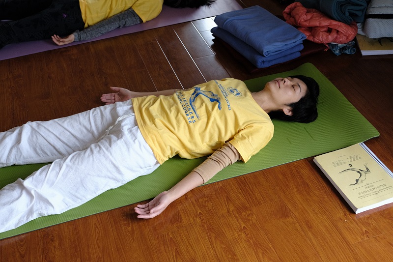 group lying savasana corpse pose