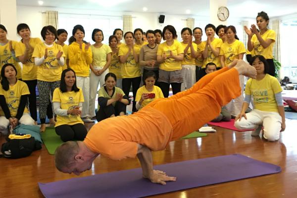 Teacher assisting students in the yoga class.